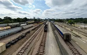 Green Energy Prints: drone photos of various rail cars and amtrak trains on a cloudy day in downtown raleigh north carolina