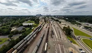 Green Energy Prints: drone photos of various rail cars and amtrak trains on a cloudy day in downtown raleigh north carolina