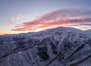 Natural Parkland Prints: Drone shot of beautifu red sunrise over snow covered frozen mountains