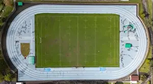 Turf Prints: Drone shot capturing the top-down view of a sports complex featuring a track