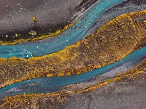 Stone Stream Prints: Drone shot river running trough black volcanic sand