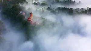 Scape Prints: drone shot of turaida castle in early morning with fog in the forest valley