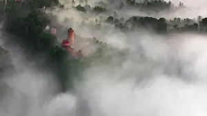 Scape Prints: drone shot of turaida castle in early morning with fog in the forest valley