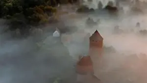 Scape Prints: drone shot of turaida castle in early morning with fog in the forest valley