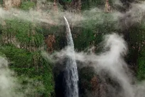 Falling Down Prints: Drone view of amazing landscape of waterfall with rapid water falling down rocky canyon