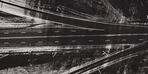 Top Drive Prints: Drone view of black and white morning empty country side road with beautiful green landscape around