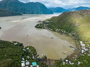 Drone view of Caleta Tortel with its small cabins - Discovering the beautiful village while traveling the Carretera
