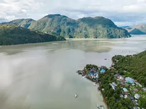 Drone view of Caleta Tortel with its small cabins - Discovering the beautiful village while traveling the Carretera