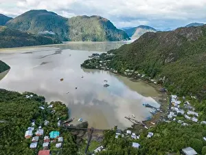Drone view of Caleta Tortel with its small cabins - Discovering the beautiful village while traveling the Carretera