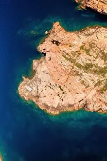 Islet Prints: Drone top view of Castelsardo's rugged coastline with serene blue waters in Sardinia