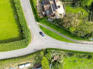 Drone top down view of a dangerous bend and road junction in rural England