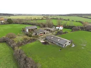 Countryside Uk Prints: Drone view of a derelict dairy farm showing the cow sheds and grain hopper