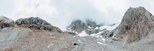 Mountain Ridge Prints: drone view over a desolate receding alpine glacier surrounded by mountains and snow covered rocks and peaks