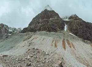 Mountain Ridge Prints: drone view over a desolate receding alpine glacier surrounded by mountains and snow covered rocks and peaks