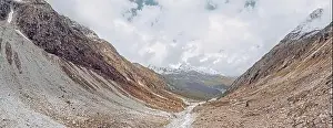 Mountain Ridge Prints: drone view over a desolate receding alpine glacier surrounded by mountains and snow covered rocks and peaks