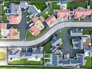 Drone top down view of detached bungalows seen at a new housing development in the English countryside