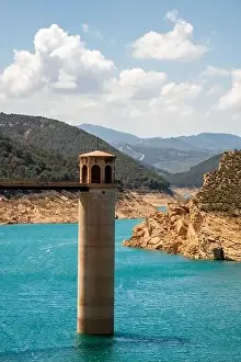 Drone view of Francisco Abellán Reservoir bridge above blue water on sunny day located in La Peza in Spain