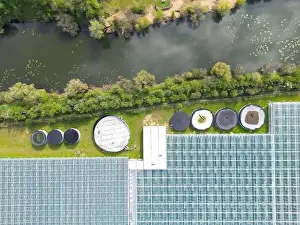 Top Down View Prints: Drone view of a part of a huge commercial glass house growing young plants