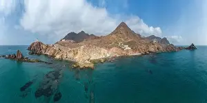 Navigate Prints: Drone view of lighthouse located on rough cliff near sea under cloudy sky in Almeria