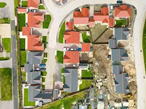 Aerial Cityscape Prints: Drone top down view of new bungalow housing development in rural England