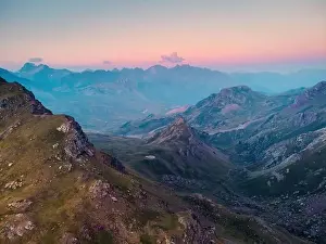 Drone view of picturesque landscape with Anayet mountain range covered with green grass under sky in Pyrenees