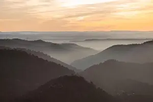 Drone view of picturesque scenery with bright sunset sky over foggy mountains and hills in Almatret