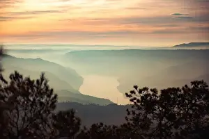 Drone view of picturesque scenery with bright sunset sky over foggy river and hills in Almatret