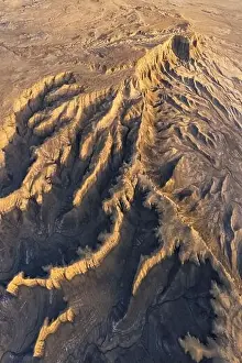 Uneven Prints: From above drone view of picturesque scenery with rough rocky formations and dry land in North Caineville Mesa