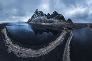Eystrahorn Prints: From above drone view of rocky mountains covered with snow located near waving seawater on south coast of Iceland