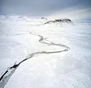 Wonderful Prints: Drone view of scenic frozen river in snowy highlands in Iceland in winter