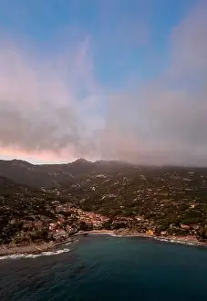 Nightfall Prints: A drone view of Seccheto Beach and village on Elba Island just after sunset with a misty purple sky