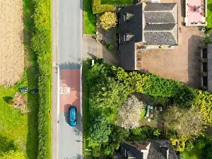 Aerial Cityscape Prints: Drone top down view of a Slow road markings seen on a dangerous rural English road