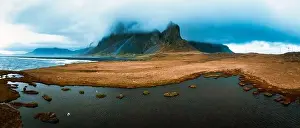 Illuminate Prints: Drone view of a snow covered Eystrahorn mountain in Iceland at Hvalnes peninsula