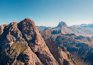 Uneven Prints: Drone view of spectacular landscape with massive rocky Anayet mountain range against blue cloudless sky in daytime