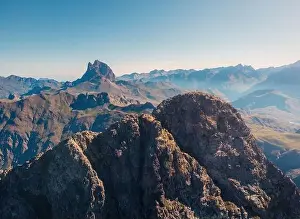 Uneven Prints: Drone view of spectacular landscape with massive rocky Anayet mountain range against blue cloudless sky in daytime