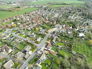 Solar Panels Prints: Drone view of a sprawling East Anglian village showing the main roadway leading through the bottom left of the image