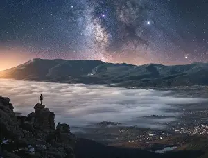 Starry Sky Prints: Drone view of traveler watching sunrise while standing on cliff