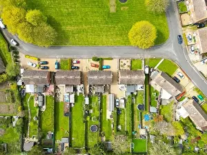 Aerial Cityscape Prints: Drone top down view of typical English semi-detached houses showing there extended gardens