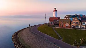 Drone view at Urk Flevoland Netherlands sunset at the lighthouse and harbor of Urk Holland