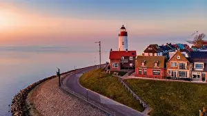 Drone view at Urk Flevoland Netherlands sunset at the lighthouse and harbor of Urk Holland