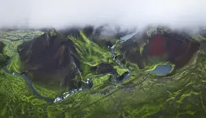 Dull Prints: From above drone view of volcanic lakes and rivers located on green mountainous terrain on cloudy day in Iceland