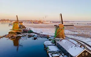 Cold Weather Prints: Drone view at the Zaanse Schans windmill village during winter with snow landscape in the Netherlands Holland village