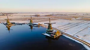 Cold Weather Prints: Drone view at the Zaanse Schans windmill village during winter with snow landscape in the Netherlands Holland village