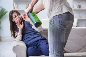 Human Being Prints: Drunk husband abusing wife in domestic violence concept