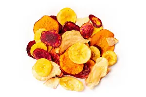 On White Prints: Dry fruit and vegetable chips, healthy vegan snack, a mixed heap on a white background