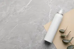 Sheet Prints: Dry shampoo spray and eucalyptus on light grey marble table, flat lay. Space for text