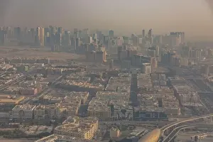 DUBAI, UAE - APRIL 29: Aerial view of Downtown Dubai and skyscrapers during morning sandstorm. Highway and trainline, soft light over the sand