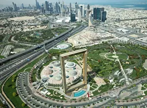 Dubai, UAE - May 18, 2018: Golden Dubai Frame viewed from above on a sunny day on the background of Dubai Downtown