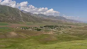 Dyudyumel, Kyrgyzstan - July 4, 2019: the small village of Dyudyumel in a valley with mountains in the background