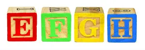 Red Green Prints: E F G H wooden toy letter blocks isolated on white